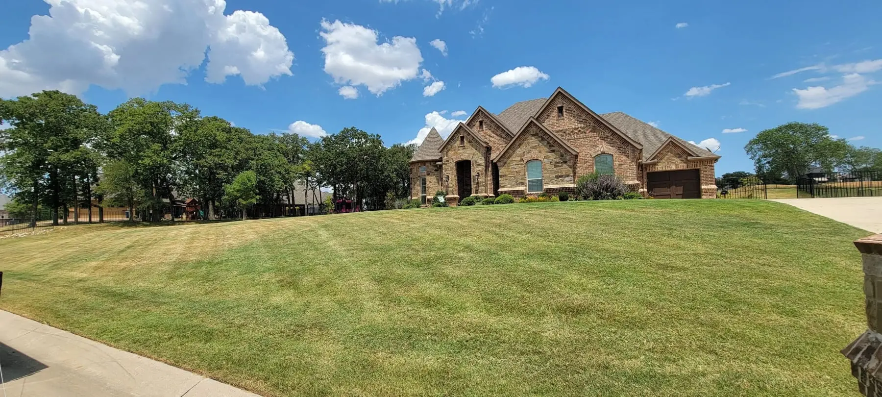 Brick home in Haslet, Texas with a neatly mowed and edged front lawn