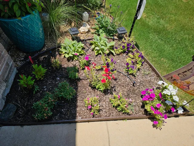 Freshly planted flower bed with mulch installed by Watson Landscaping