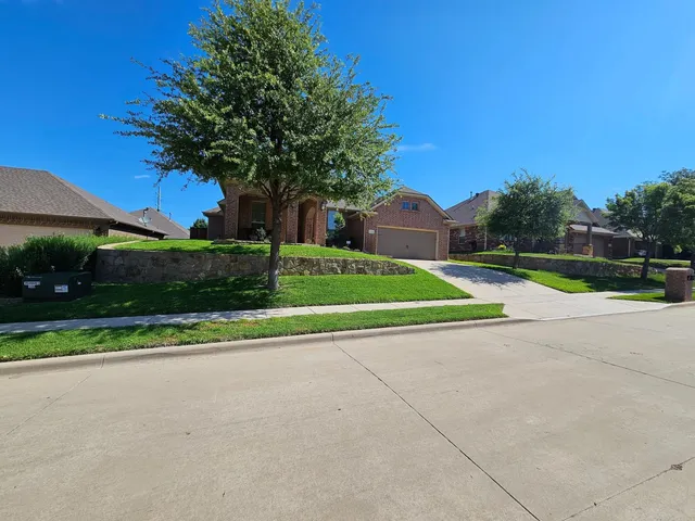 Edged sidewalk and mowed lawn on a corner lot in North Fort Worth
