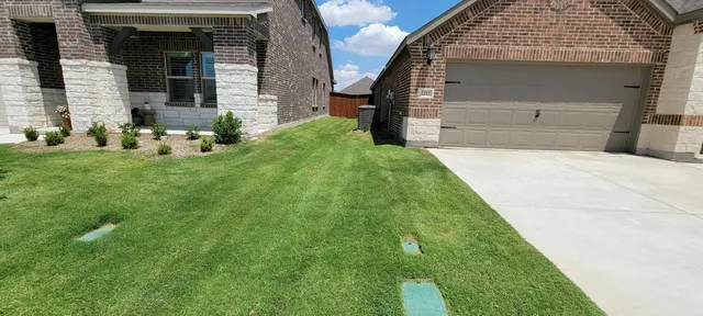 Striped lawn along a driveway in a North Fort Worth subdivision