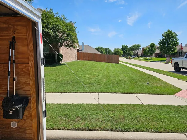Sidewalk edged and lawn mowed on a corner lot