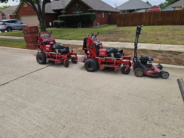 Commercial mowers and trailer at a North Fort Worth job